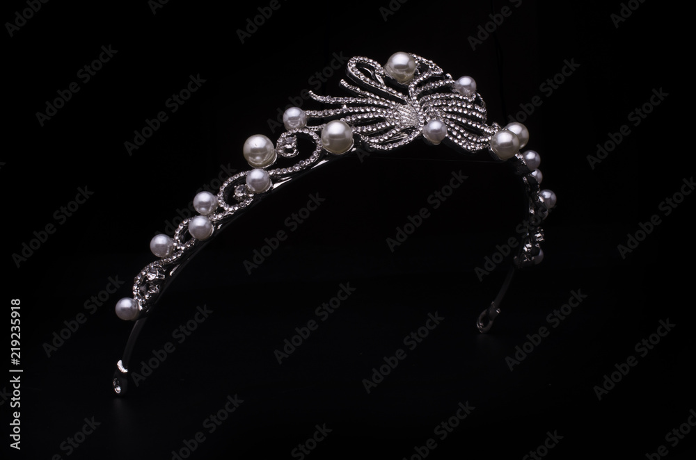Fototapeta premium silver diadem with swans isolated on black
