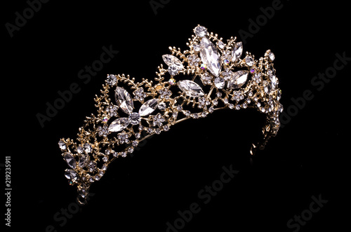 gold diadem with diamonds isolated on back photo