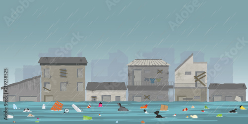 Heavy rain drops and city flood in slum city with garbage floating in the water.