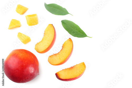 Nectarine with green leaf and slices isolated on white background. top view
