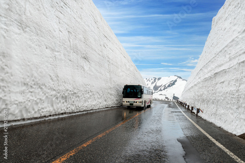 Snow wall at Kurobe alpine in Japan with bus for tourists on Tateyama Kurobe Alpine Route, Japanese Alp in Tateyama, Japan photo