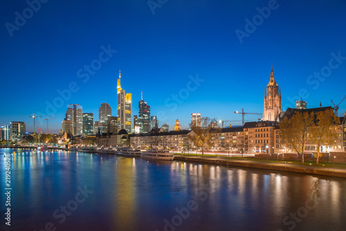 View of Frankfurt am Main skyline at dusk along Main river with cruise ship in Frankfurt  Germany