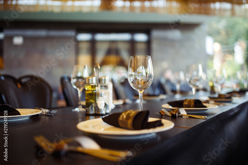 Sparkling glassware stands on long table prepared for wedding dinner Fototapeta