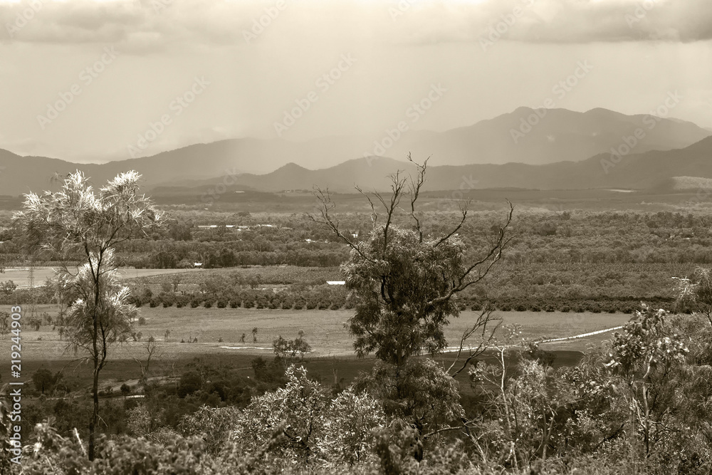 Obraz premium Sepia tinted storm over hills on the Atherton Tableland in Queensland, Australia
