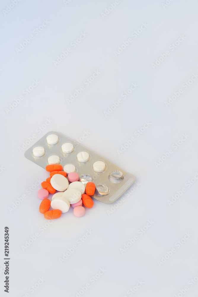 Tablets and blister pack on white background
