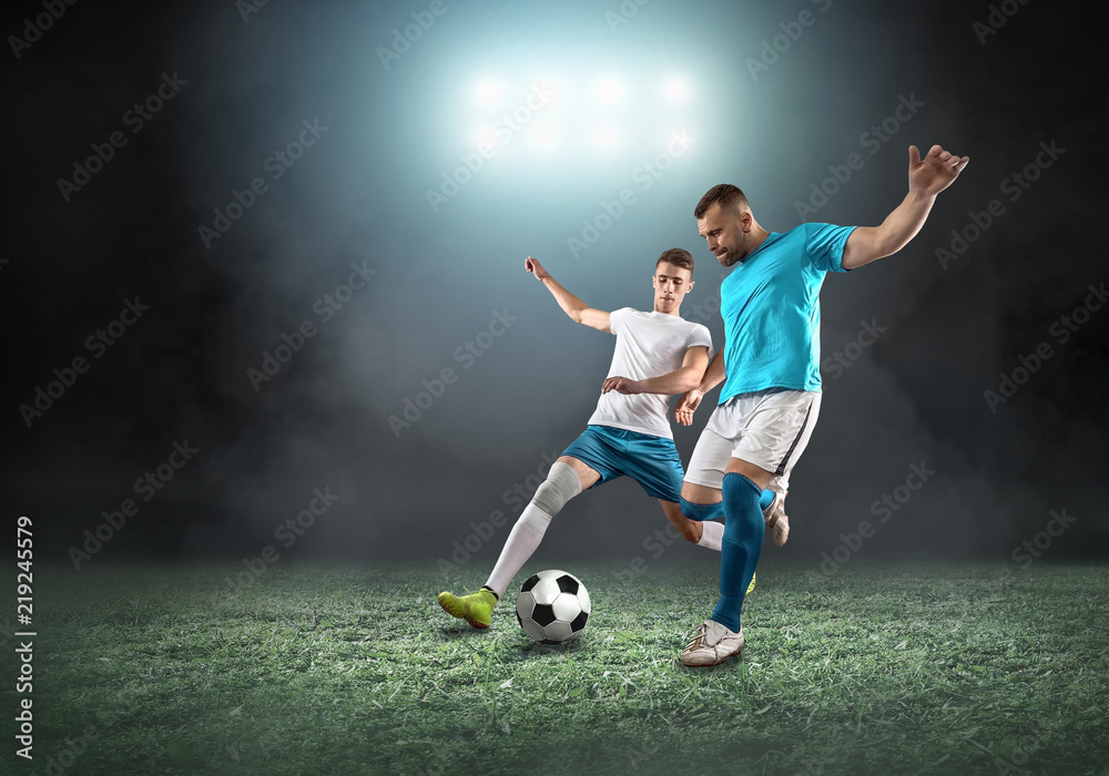 Soccer player on a football field in dynamic action at summer day Soccer player on a football field in dynamic action at summer day
