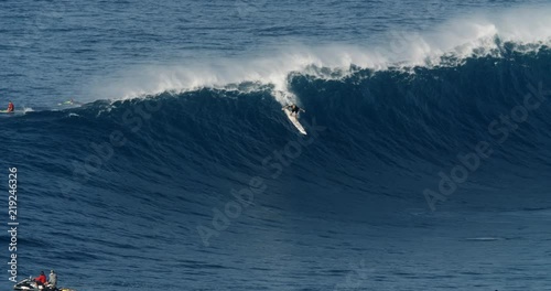 Male big wave surfer on a large wave during high surf conditions