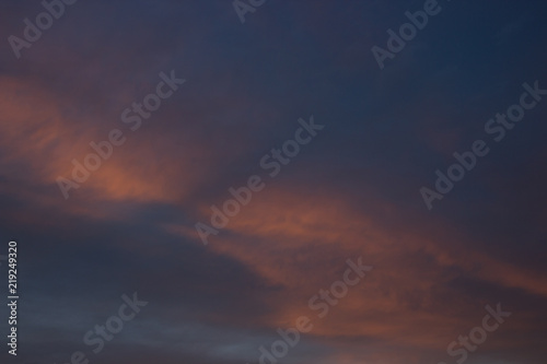 View on beautiful pink clouds in a pink blue sky. © beldesigne