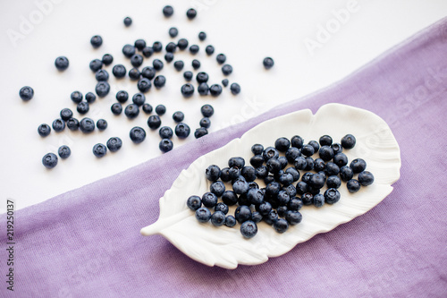 Blueberries on a white table.