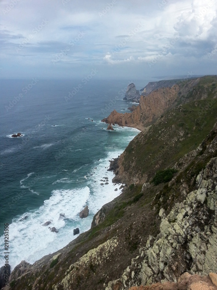 High view on the stony cliffs with waves at the seaside in portugal