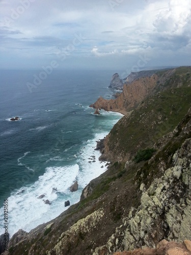 High view on the stony cliffs with waves at the seaside in portugal