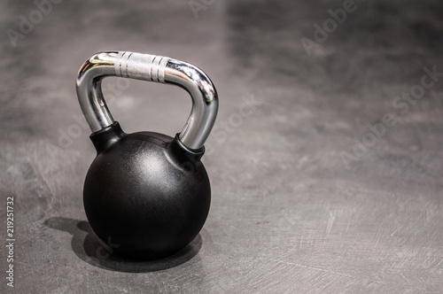 Fototapeta Naklejka Na Ścianę i Meble -  health and sport lifestyle concept, steel athletic kettlebell weight in a black shell