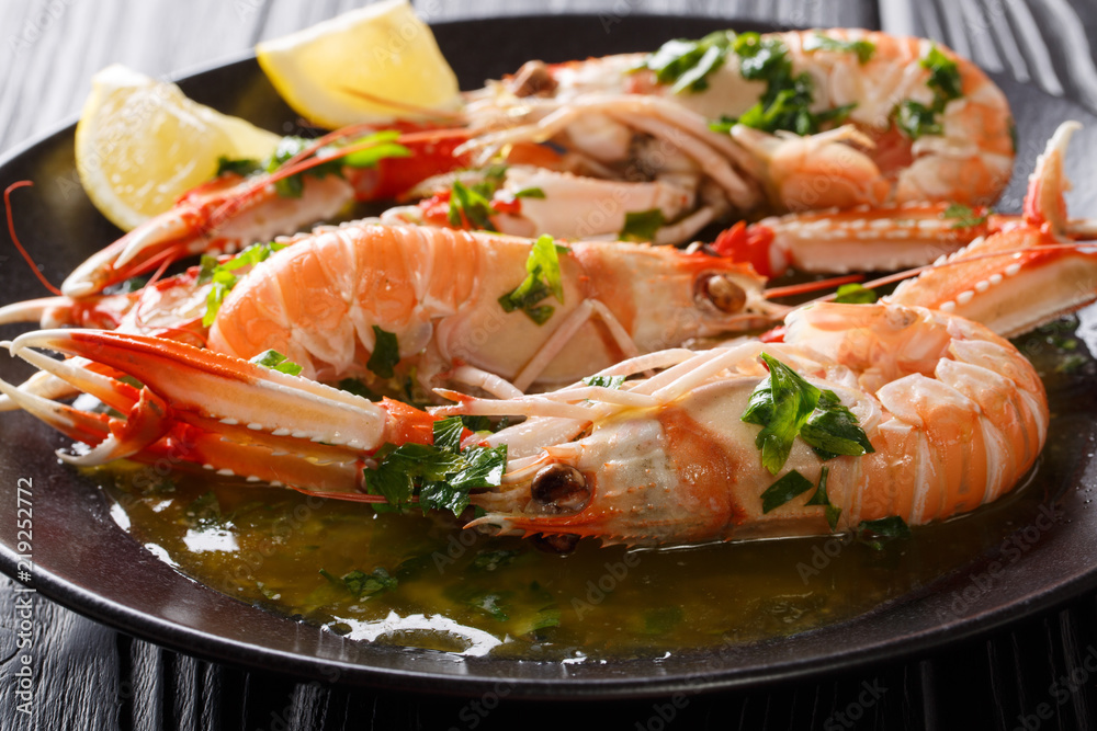 Boiled Nephrops norvegicus, Norway lobster, Dublin Bay prawn, langoustine or scampi close-up with sauce and lemon. horizontal Boiled Nephrops norvegicus, Norway lobster, Dublin Bay prawn, langoustine or scampi close-up with sauce and lemon. horizontal