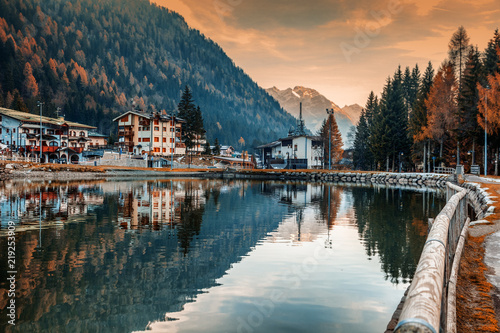 Fototapeta A small town in the Dolomites Italian Alps, a lake, a beautiful urban natural au