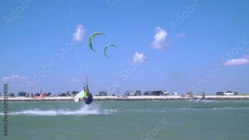 A male kiter performs a coup in the air photo