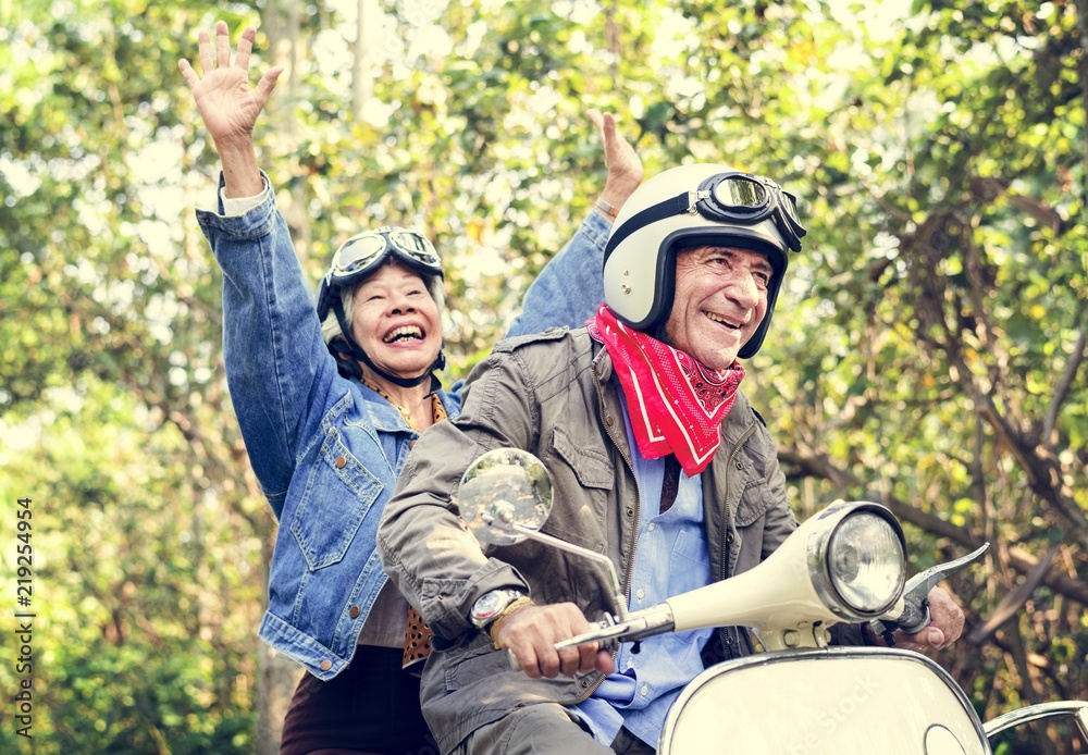 Fototapeta premium Senior couple riding a classic scooter