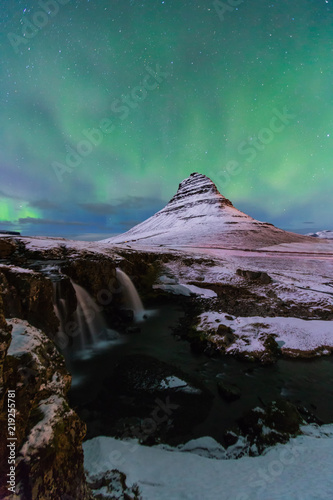 Aurora Borealis or northern light above kirkjufell mountain in iceland