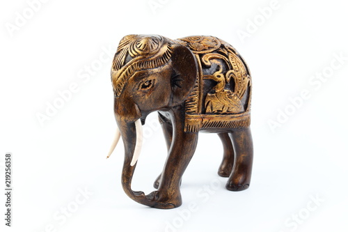 gold and brown elephant made of resin like wood carving with candle holder with white sesame. Stand on white background, Isolated, Art Model Thai Crafts, For decoration Like in the spa.