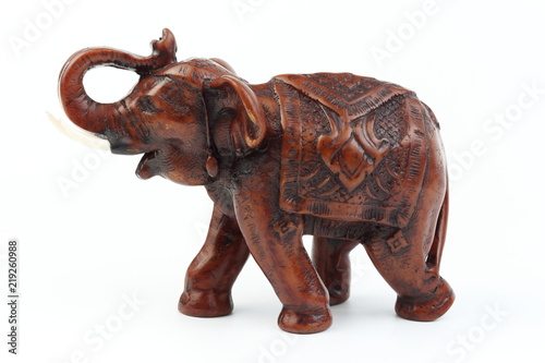 Brown elephant made of resin like wood carving with candle holder with white ivory. Stand on white background  Isolated  Art Model Thai Crafts  For decoration Like in the spa.