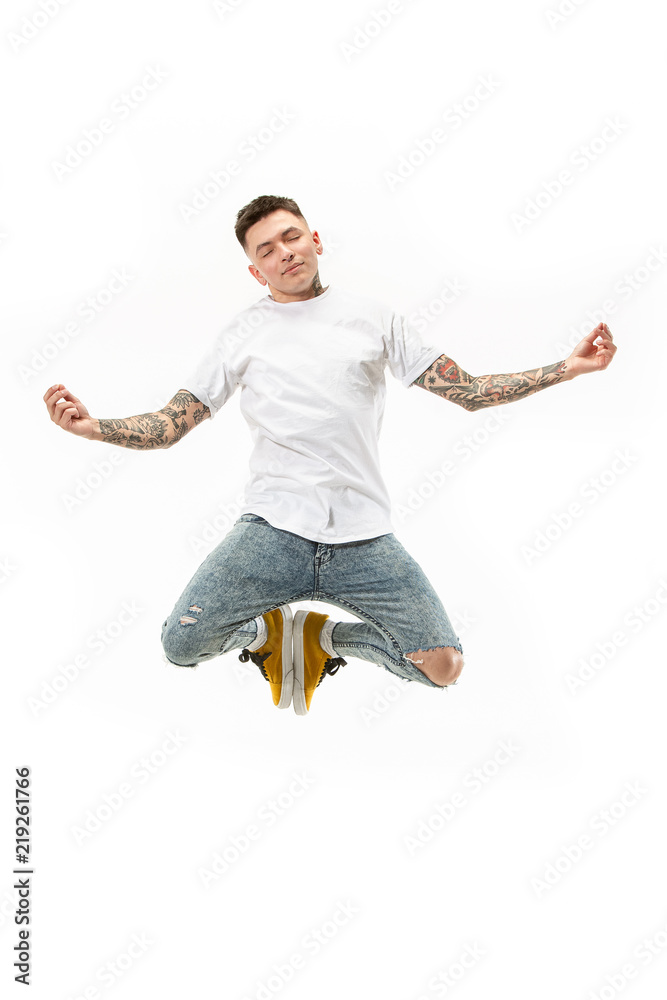 Yoga in moving. handsome young man jumping against white background Yoga in moving. handsome young man jumping against white background