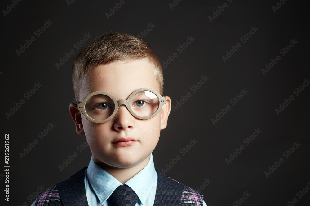 intelligent child in glasses near school desk intelligent child in glasses near school desk
