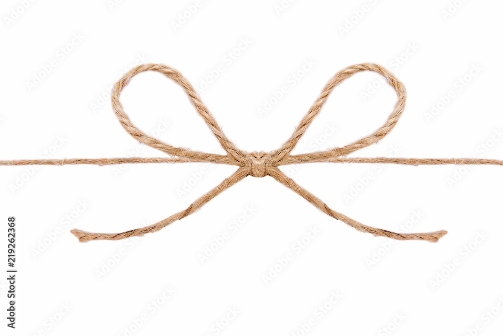 Natural brown jute twine hemp rope, tie a knot / bow in the middle of the cord. Isolated on white background.