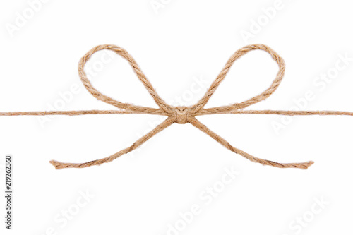 Natural brown jute twine hemp rope, tie a knot / bow in the middle of the cord. Isolated on white background.