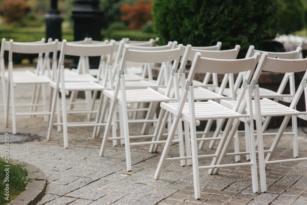 White chair on wedding ceremony. summer wedding decoration outside