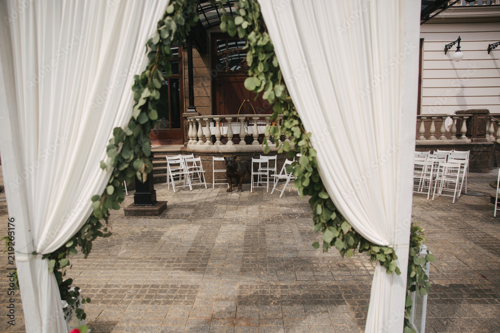 Weddind decoration on open air. Floral decor of a beautiful white arch Weddind decoration on open air. Floral decor of a beautiful white arch