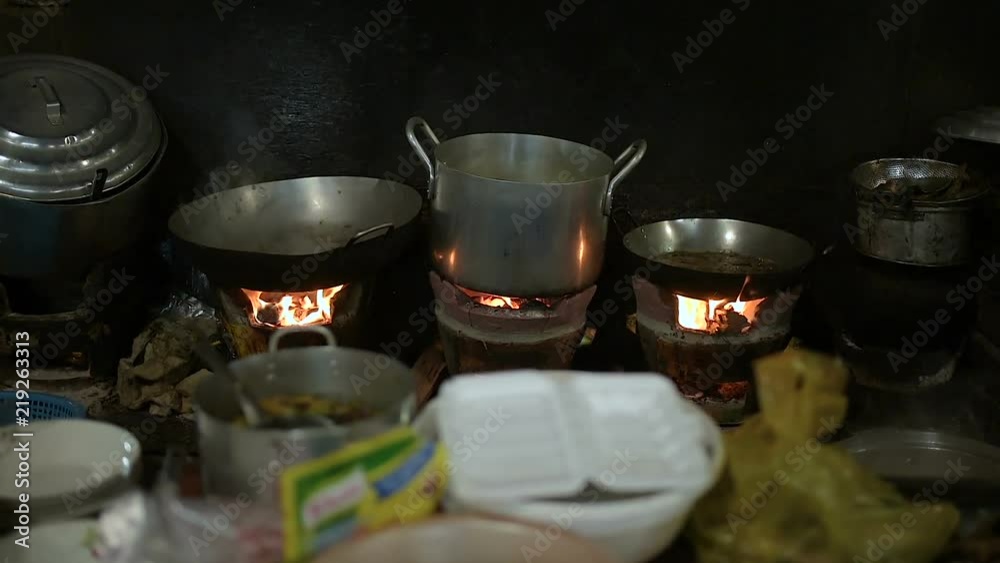 Aluminum pot on the fire on the local market. Local Aluminum pot on the fire on the local market. Local