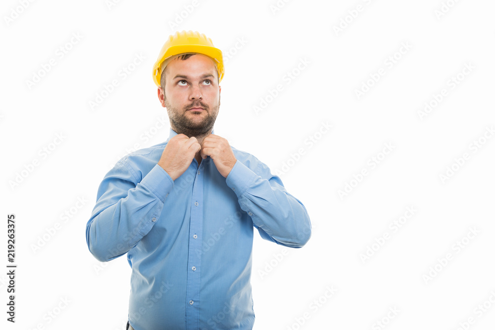 Young architect with yellow helmet arranging collar shirt Young architect with yellow helmet arranging collar shirt