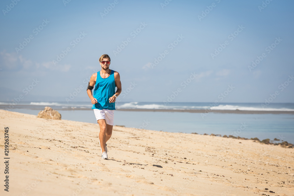 handsome sportsman running on sea shore handsome sportsman running on sea shore