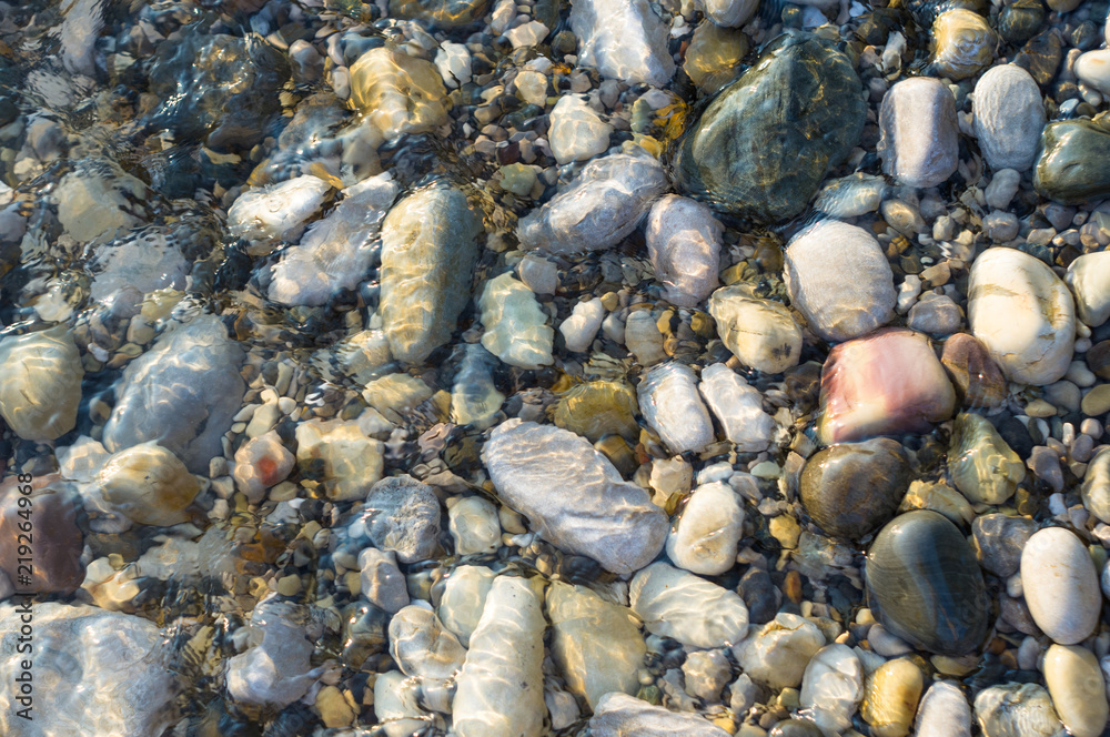 pebble stones on the sea beach, the rolling waves of the sea with foam pebble stones on the sea beach, the rolling waves of the sea with foam