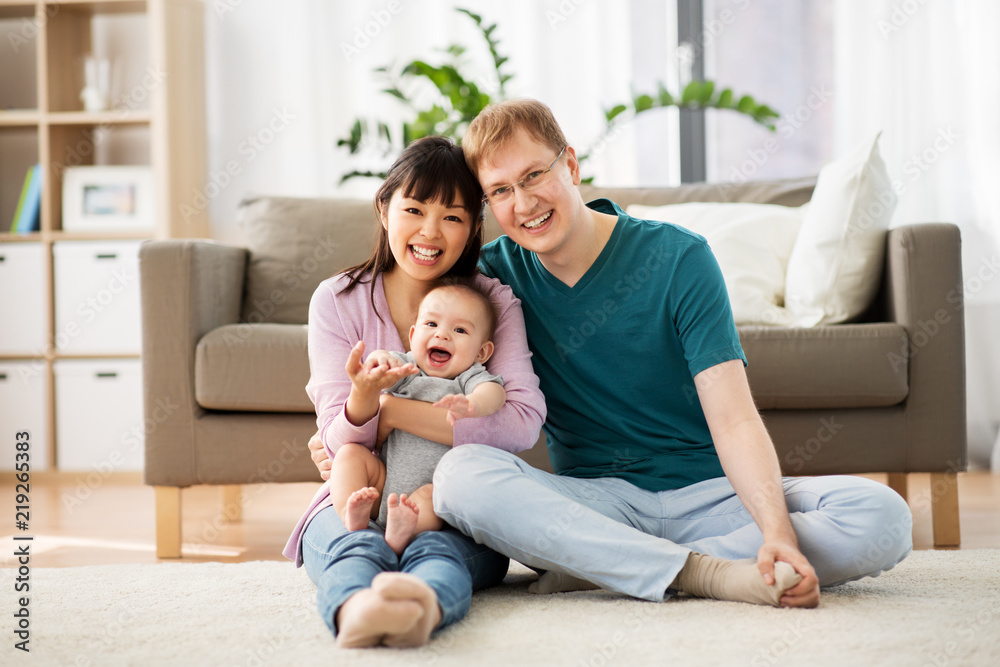 family, parenthood and people concept - happy mother and father with baby boy at home