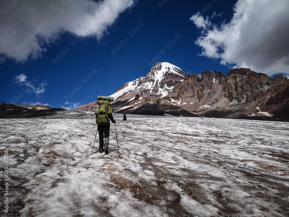 Mount climber walking towards Mount Kazbek