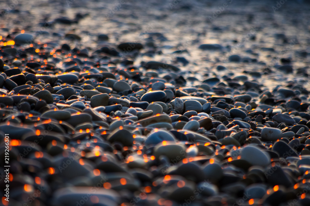 Fototapeta premium pebble stones on the sea beach, the rolling waves of the sea with foam
