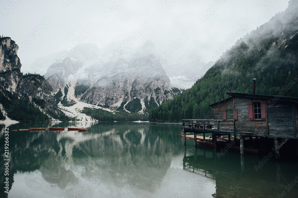 picture view of Pragser Wildsee Lake and wooden pier, Prags Dolomites in South Tyrol, Italy