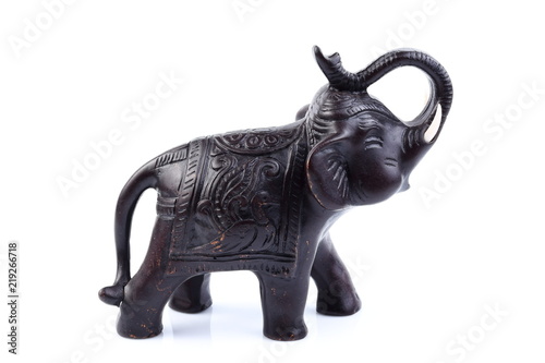 Black elephant made of resin like wooden carving with white ivory. Stand on white background, Isolated, Art Model Thai Crafts, For decoration Like in the spa. © Thanachai