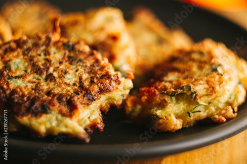 Fried vegetable fritters with zucchini, carrots, herbs, eggs, and cheese.