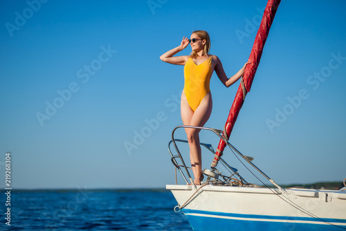 Girl standing on the bow of the yacht, sailboat. Copy space