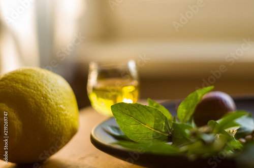 Fresh ingredients for preparing Italian pesto sauce - lemon basil sprigs, peeled seeds of cedar nuts, large garlic clove, Greek olive oil, Parmesan cheese photo