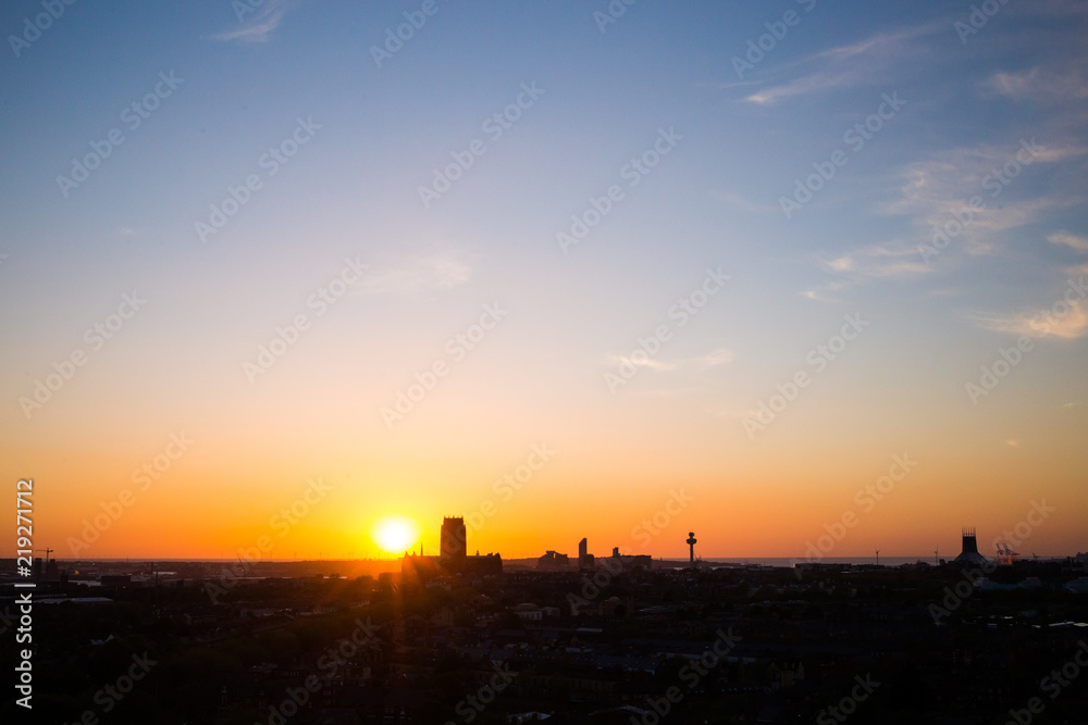 Sunset over liverpool with liverpool cathedral and radio city tower silhouettes