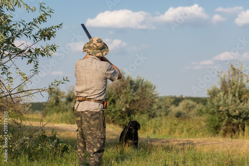 Hunter with a German trotter and spaniel, hunting a pheasant with dogs 