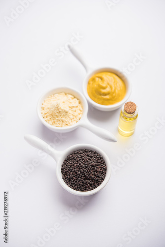 Rai or raw Mustard with sauce  powder and oil  over moody background. Selective focus 