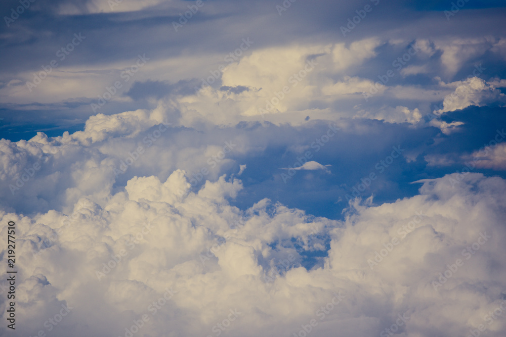 Blue sky background with beautiful clouds in sky. View from the window airplane flying. Blue sky background with beautiful clouds in sky. View from the window airplane flying.