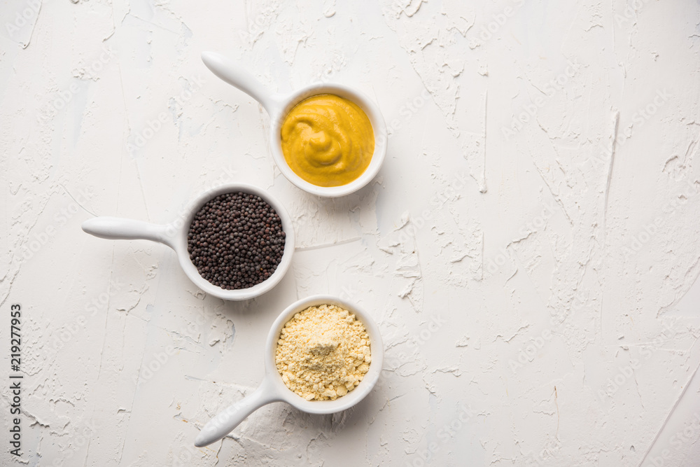 Rai or raw Mustard with sauce, powder and oil, over moody background. Selective focus
Rai or raw Mustard with sauce, powder and oil, over moody background. Selective focus