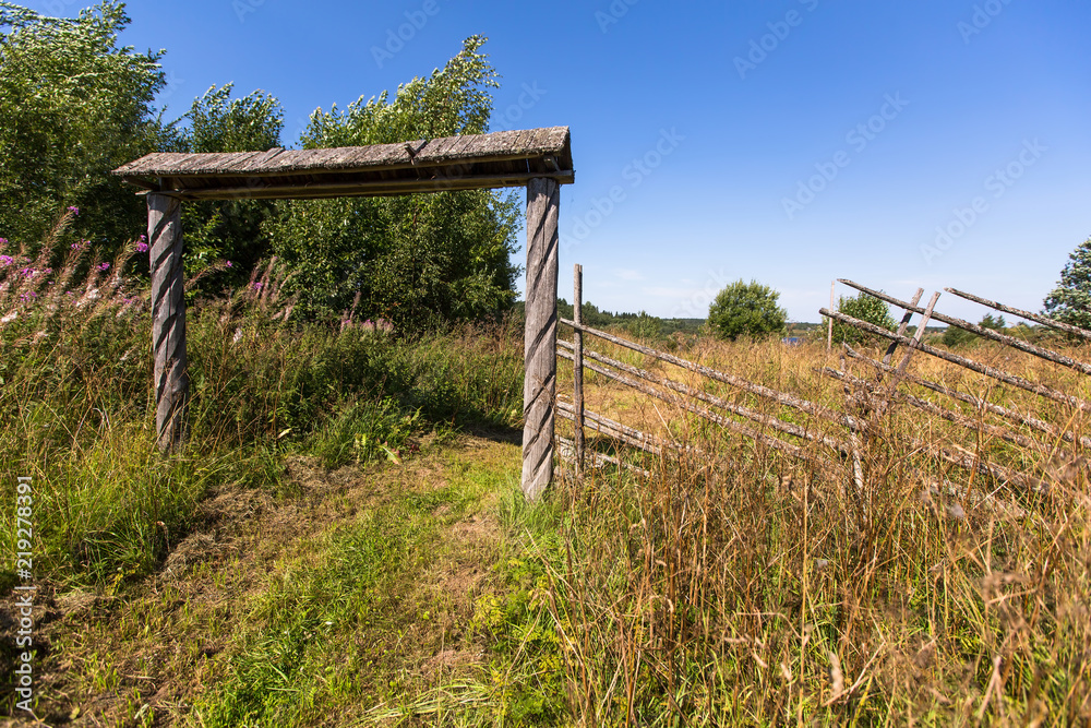 Wooden gate and field in the village.