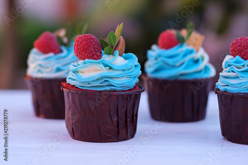 beautiful cupcakes with raspberries and almonds