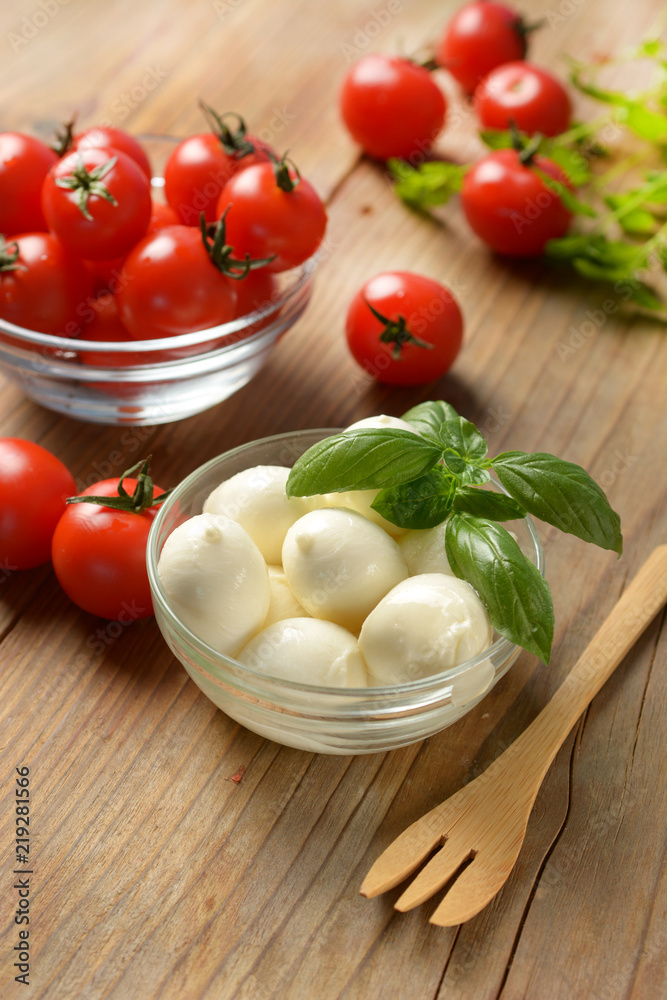 small mozzarella with cherry tomatoes in the glass bowl