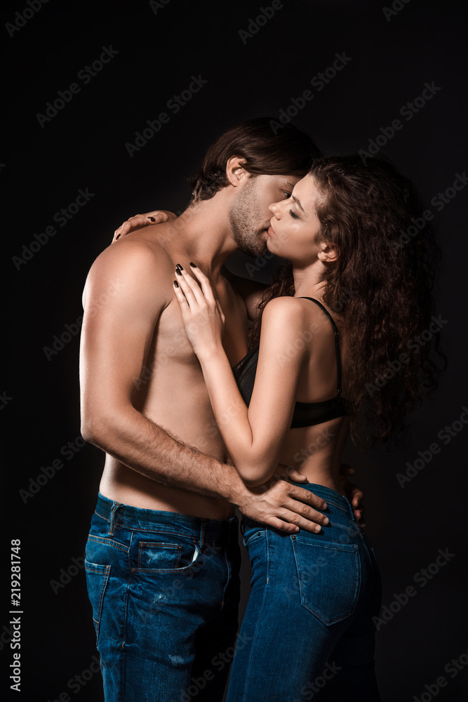 side view of sexy shirtless couple kissing isolated on black side view of sexy shirtless couple kissing isolated on black